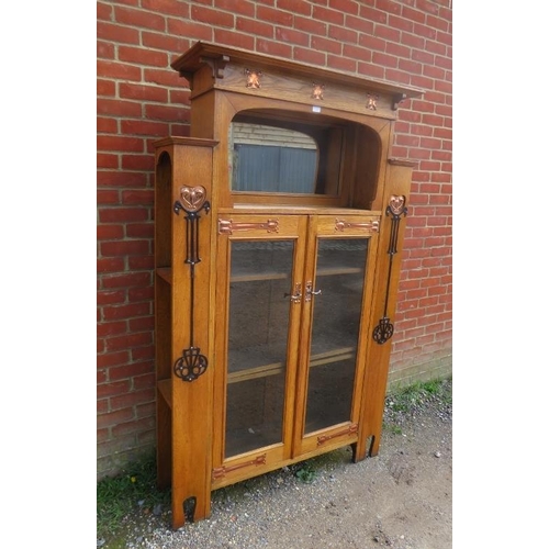 723 - An Arts & Crafts light oak glazed cabinet in the manner of Glasgow school, the stepped cornice above... 