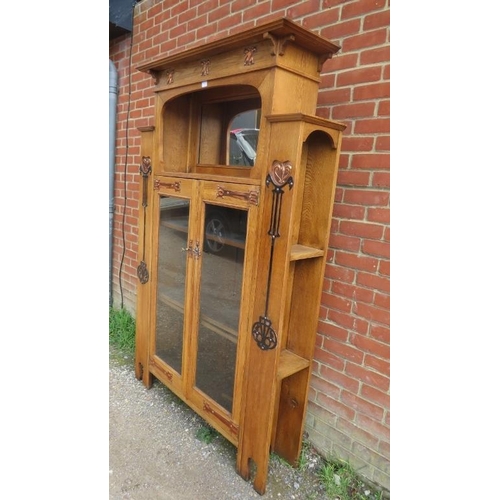 723 - An Arts & Crafts light oak glazed cabinet in the manner of Glasgow school, the stepped cornice above... 