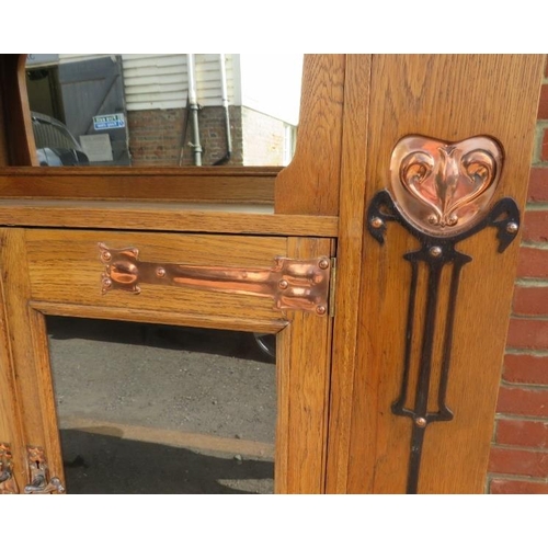 723 - An Arts & Crafts light oak glazed cabinet in the manner of Glasgow school, the stepped cornice above... 