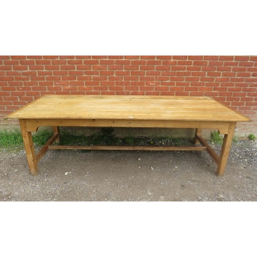 724 - An antique pine refectory style farmhouse table, the planked top on square supports united by an ‘H’... 