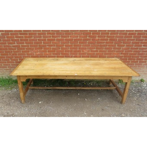 724 - An antique pine refectory style farmhouse table, the planked top on square supports united by an ‘H’... 