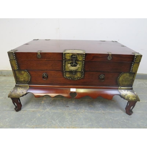 726 - A Chinese hardwood chest, having engraved brass mounts, the hinged top compartment above one long dr... 