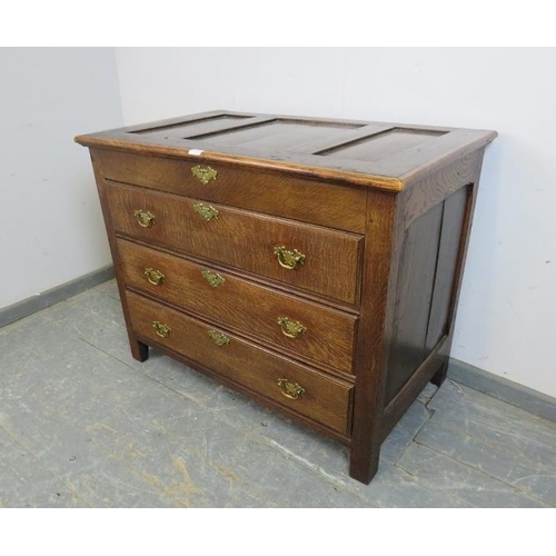 727 - An antique oak chest in the 18th century taste, the panelled lid opening onto a shallow compartment,... 