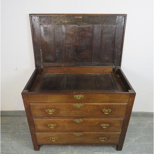 727 - An antique oak chest in the 18th century taste, the panelled lid opening onto a shallow compartment,... 