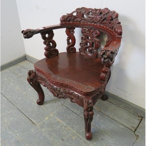 728 - An antique Chinese lacquered tub chair, having intricately carved & pierced backrest in high relief,... 