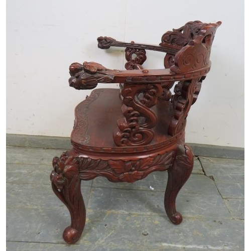 728 - An antique Chinese lacquered tub chair, having intricately carved & pierced backrest in high relief,... 