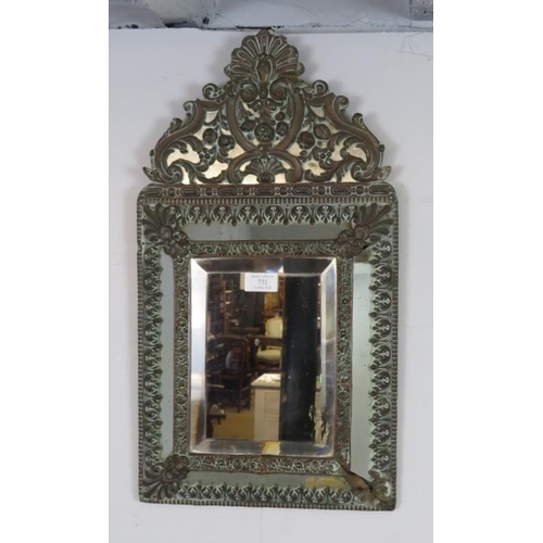 731 - A 19th century Napoleon III cushion wall mirror, the sectioned mirror plates within a brass repousse... 