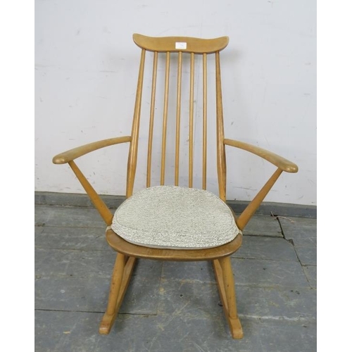 734 - A mid-century blond elm & beech ‘Goldsmiths’ rocking chair by Ercol (model 435) on canted supports w... 