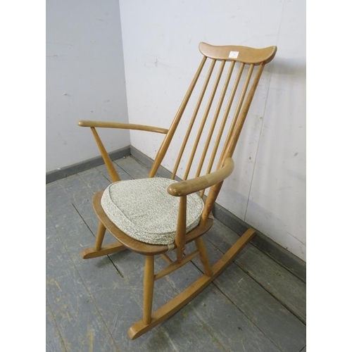 734 - A mid-century blond elm & beech ‘Goldsmiths’ rocking chair by Ercol (model 435) on canted supports w... 