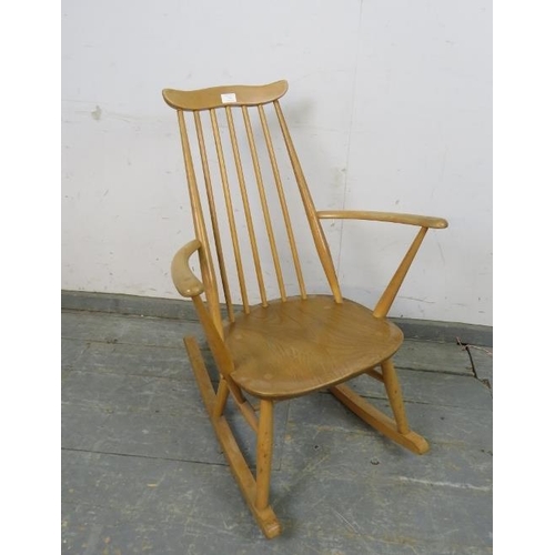 734 - A mid-century blond elm & beech ‘Goldsmiths’ rocking chair by Ercol (model 435) on canted supports w... 