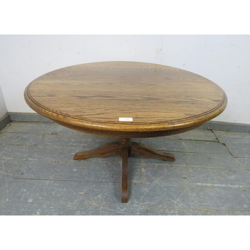 740 - A vintage solid medium oak circular coffee table, on a bulbous turned column with quatreform base. 
... 