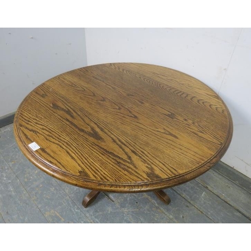 740 - A vintage solid medium oak circular coffee table, on a bulbous turned column with quatreform base. 
... 