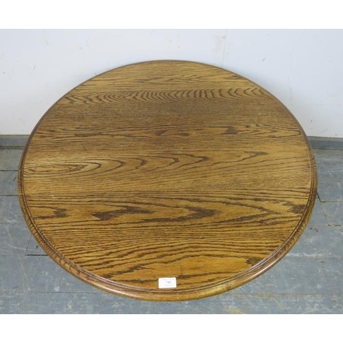 740 - A vintage solid medium oak circular coffee table, on a bulbous turned column with quatreform base. 
... 