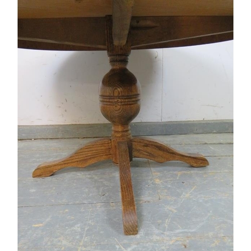 740 - A vintage solid medium oak circular coffee table, on a bulbous turned column with quatreform base. 
... 