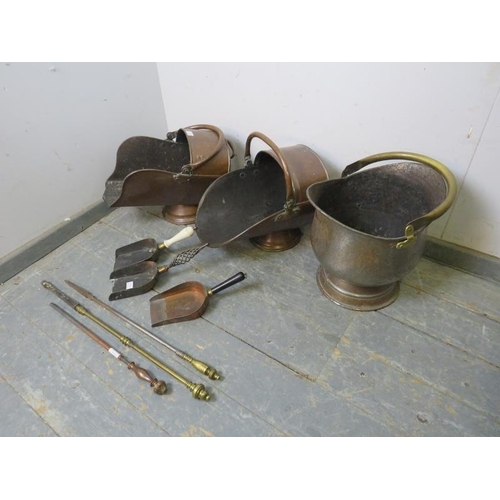 744 - A mixed lot of antique brass and copper comprising three coal scuttles with scoops and three pokers.... 