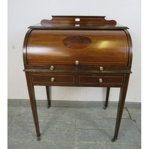 746 - An Edwardian mahogany cylinder writing desk strung with boxwood, the lid opening onto a fitted inter... 