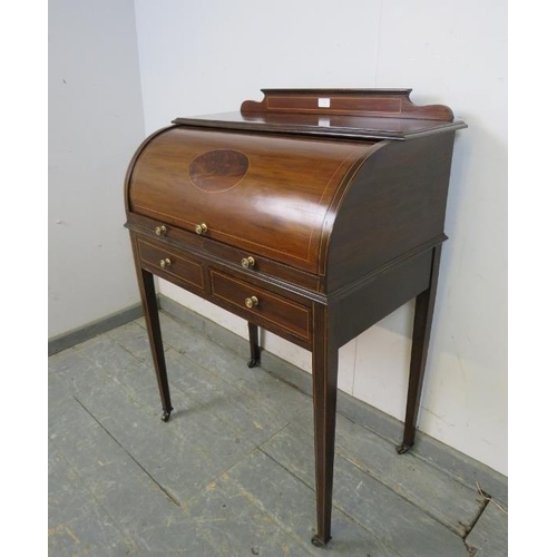 746 - An Edwardian mahogany cylinder writing desk strung with boxwood, the lid opening onto a fitted inter... 