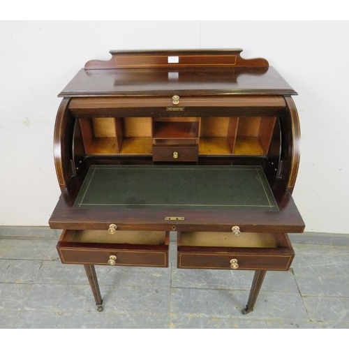 746 - An Edwardian mahogany cylinder writing desk strung with boxwood, the lid opening onto a fitted inter... 