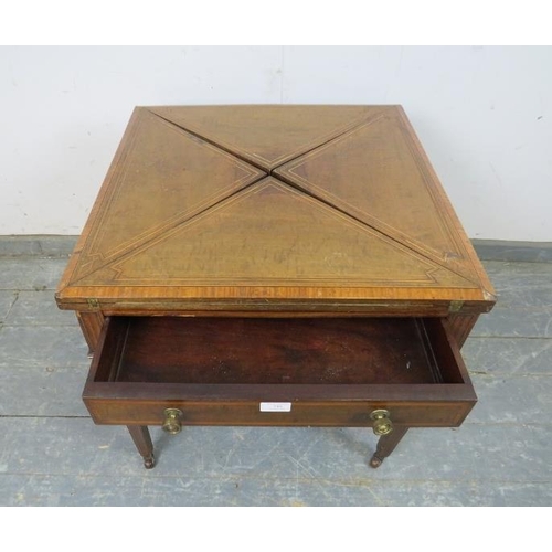 748 - An Edwardian mahogany inlaid and crossbanded envelope card table, having one long frieze drawer, on ... 