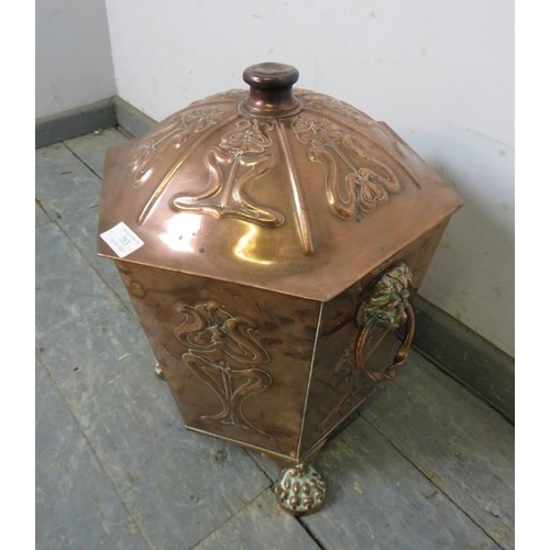 753 - An Arts & Crafts Period hexagonal copper coal bucket, having repousse decoration and lion mask drop-... 