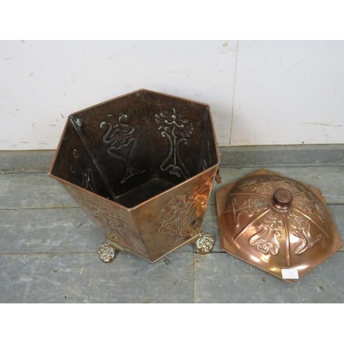 753 - An Arts & Crafts Period hexagonal copper coal bucket, having repousse decoration and lion mask drop-... 