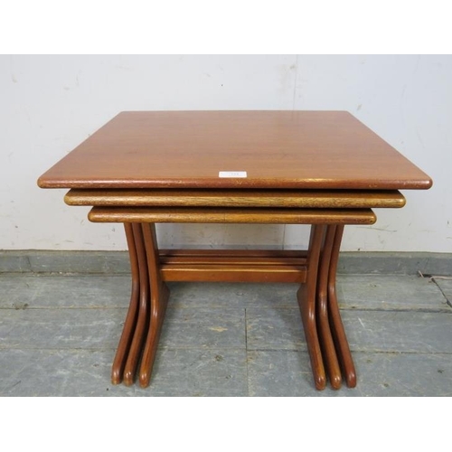 755 - A set of three mid-century teak graduated nesting tables by G-Plan, on curved supports with stretche... 