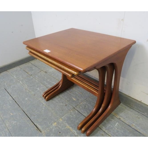 755 - A set of three mid-century teak graduated nesting tables by G-Plan, on curved supports with stretche... 