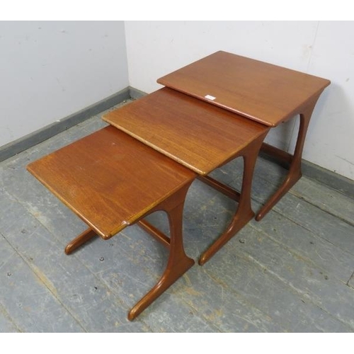 755 - A set of three mid-century teak graduated nesting tables by G-Plan, on curved supports with stretche... 