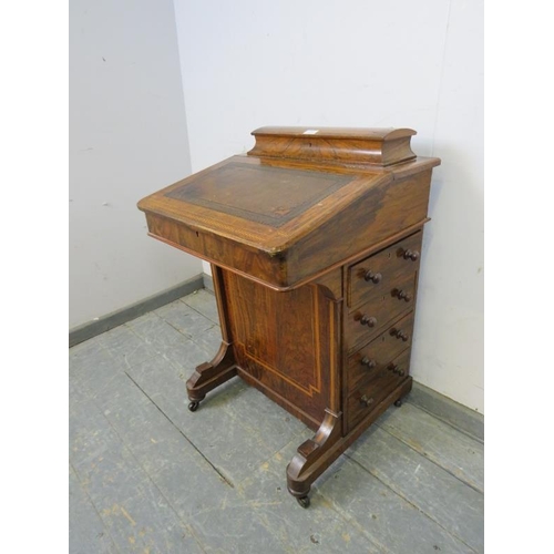 757 - A Victorian figured walnut Davenport, inlaid and crossbanded, the gallery opening onto fitted statio... 