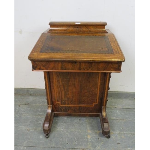 757 - A Victorian figured walnut Davenport, inlaid and crossbanded, the gallery opening onto fitted statio... 