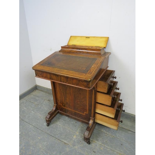 757 - A Victorian figured walnut Davenport, inlaid and crossbanded, the gallery opening onto fitted statio... 