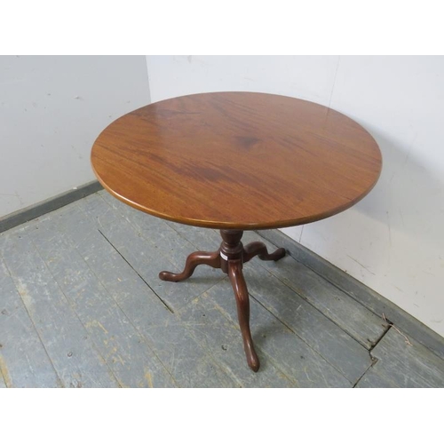 759 - An early Victorian mahogany tilt-top supper table of good colour, on a tapering turned pedestal with... 