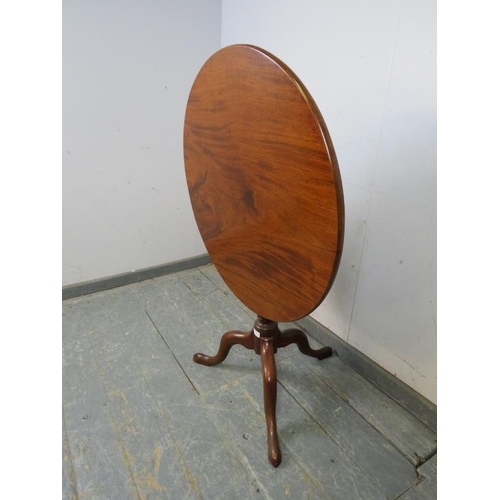 759 - An early Victorian mahogany tilt-top supper table of good colour, on a tapering turned pedestal with... 