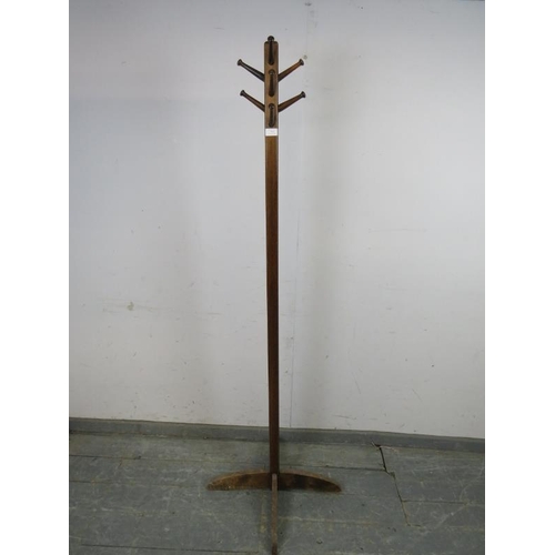 763 - An Art Deco Period mahogany coat stand, having a selection of 10 turned peg hooks, the square column... 