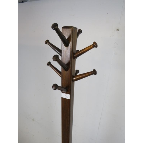 763 - An Art Deco Period mahogany coat stand, having a selection of 10 turned peg hooks, the square column... 