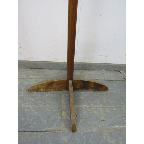 763 - An Art Deco Period mahogany coat stand, having a selection of 10 turned peg hooks, the square column... 