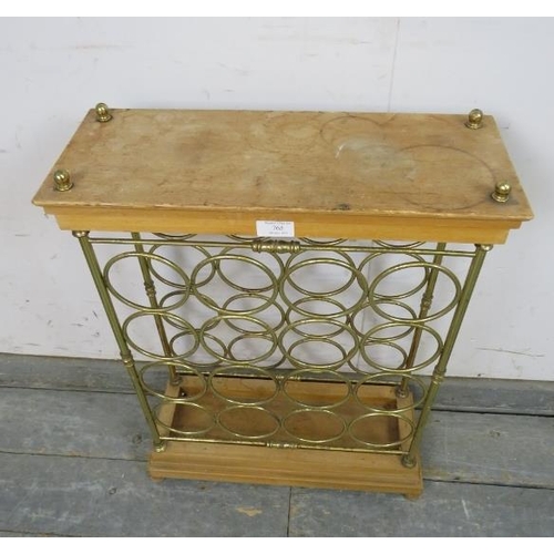 765 - A vintage beech and brass wine rack (capacity 16 bottles) with brass ball finials, on a stepped plin... 