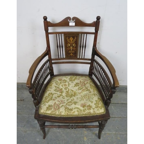 770 - An Edwardian mahogany elbow chair, having marquetry inlaid back panel and turned spindles, above a t... 