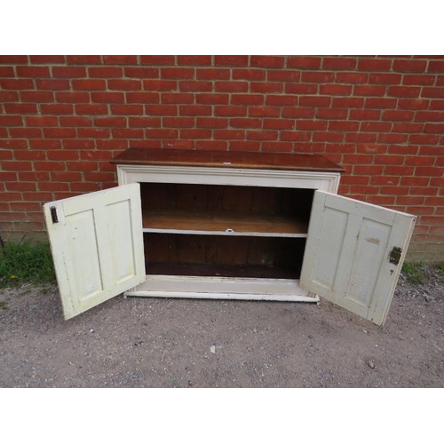 772 - An antique kitchen sideboard, the fruitwood top above a cream painted base, having twin panelled doo... 