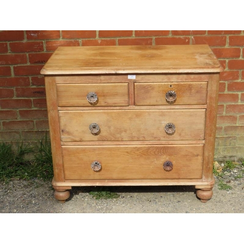 787 - An antique pine chest, housing two short above two long graduated drawers with fluted glass knob han... 