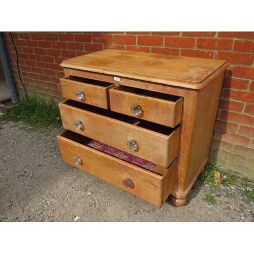 787 - An antique pine chest, housing two short above two long graduated drawers with fluted glass knob han... 