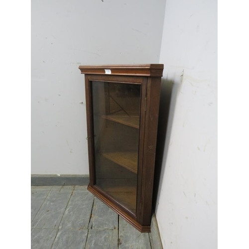 788 - A reproduction mahogany wall hanging glazed corner cupboard, having a moulded cornice above two loos... 