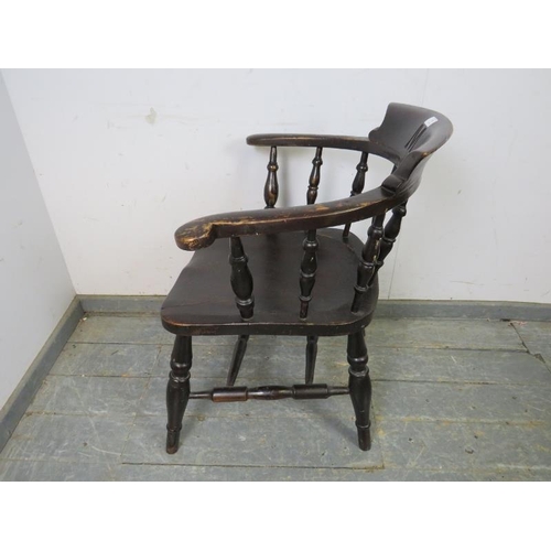 790 - A turn of the century ebonised captain’s chair, carved with the initial ‘M’ the scrolled arms joined... 