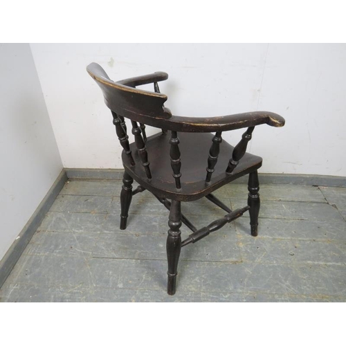 790 - A turn of the century ebonised captain’s chair, carved with the initial ‘M’ the scrolled arms joined... 