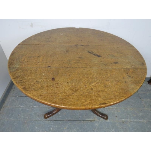 793 - A 19th century medium oak tilt-top supper table, on a ring turned column with splayed tripod support... 