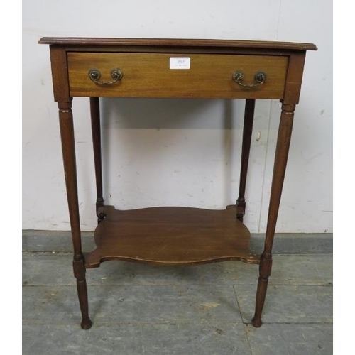 803 - An Edwardian mahogany two-tier worktable, having one long frieze drawer with reeded brass handles an... 