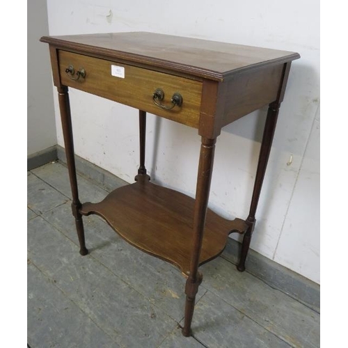 803 - An Edwardian mahogany two-tier worktable, having one long frieze drawer with reeded brass handles an... 