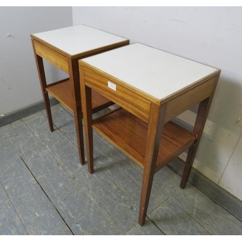 814 - A pair of mid-century teak two-tier side tables, the inset formica tops above blind drawers, on tape... 