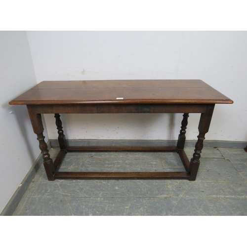 815 - A 19th century oak serving table, on turned and block supports with stretchers. 
H68cm W129cm D49cm ... 