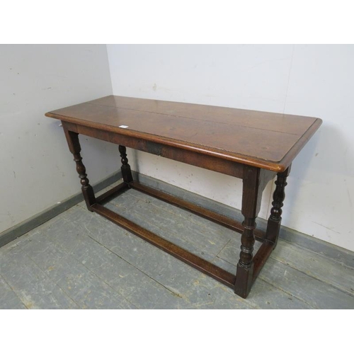 815 - A 19th century oak serving table, on turned and block supports with stretchers. 
H68cm W129cm D49cm ... 